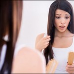 woman finding hair in hair brush