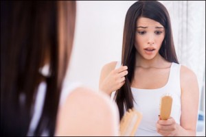 woman finding hair in hair brush