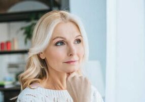 middle aged woman experiencing hair thinning and loss - unique solutions in New Bedford