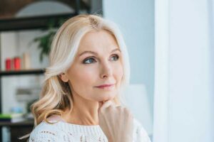 middle aged woman experiencing hair thinning and loss - unique solutions in New Bedford