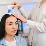 closeup of a woman receiving a scalp treatment for hair loss