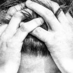 man with hands in his hair